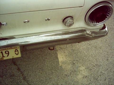 1962 Ford Falcon - The rear of a 1962 Ford Falcon shows its chrome bumper, taillight, and a license plate from Illinois.