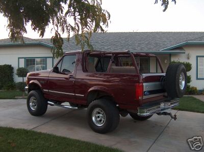 1996 Ford Bronco - Top Off. Showing a customized, fabricated roll cage that fits up under the factory hardtop. Which is custom fitted with Burgandy Leather up…