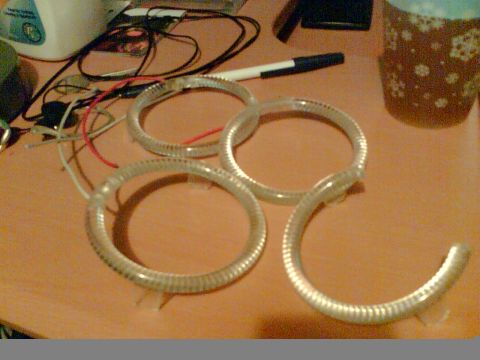 1997 Ford Probe - Close-up of four clear plastic rings with visible wiring, likely automotive lighting components.