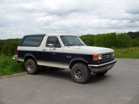 1988 Ford Bronco - This 1988 Ford Bronco features a distinctive two-tone paint scheme with blue and white sections.