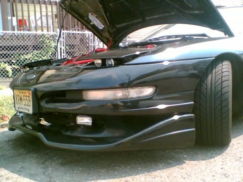 1997 Ford Probe - Front view of a black car with its hood open, revealing engine components. The license plate reads KRM-55B.