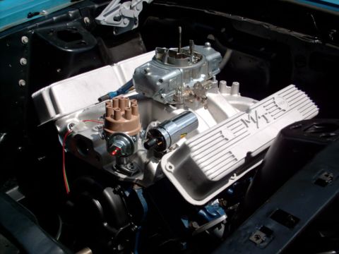 1986 Ford Bronco - The engine bay shows a V8 motor with aftermarket valve covers and a carburetor.