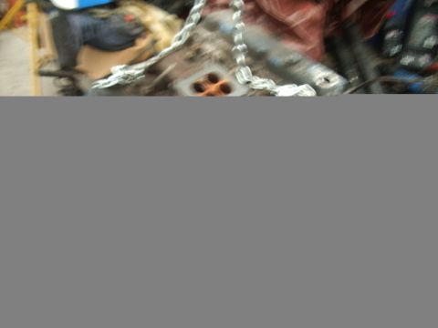 1978 Ford Bronco - Engine parts are visible, including a block with orange openings and a chain.