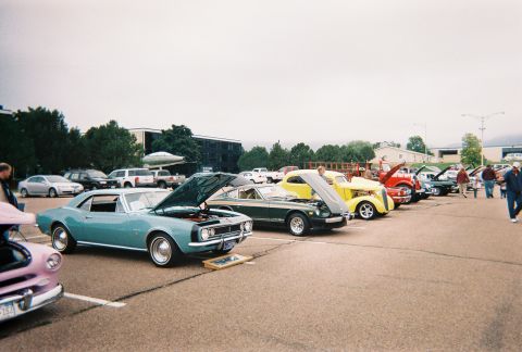 1972 Ford Ranchero - A collection of vintage automobiles are showcased at an outdoor event, with many having their hoods open for viewing.