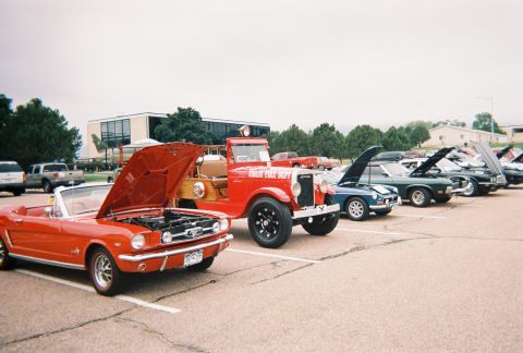 1972 Ford Ranchero - A variety of vehicles are displayed with their hoods open at an outdoor event.