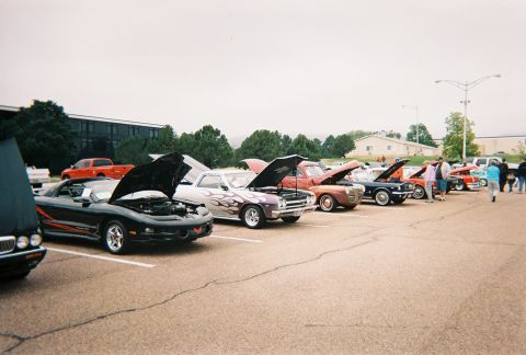 1972 Ford Ranchero - Several cars are parked in a lot with their hoods open, suggesting a car show event.