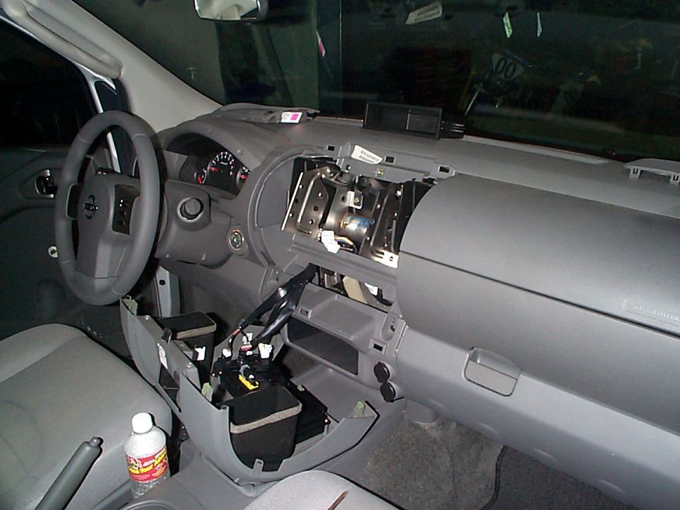 2005 Nissan Frontier interior with dashboard disassembled, showing wiring and components