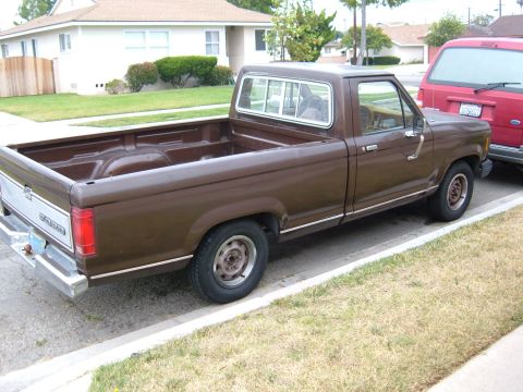 1985 Ford Ranger - Brown 1985 Ford Ranger pickup truck parked curbside in a neighborhood.