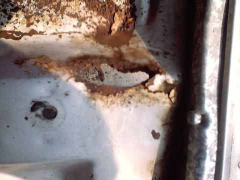 1966 Ford Fairlane - Close up of rust hole after finishing it off with the hammer you saw in previous picture.