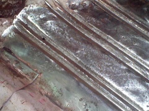 1966 Ford Fairlane - Close-up of a metal floor panel showing ribbed texture and signs of preparation for painting.