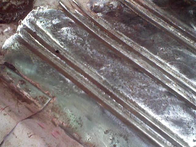 Corrugated metal floor panel with rust and green primer