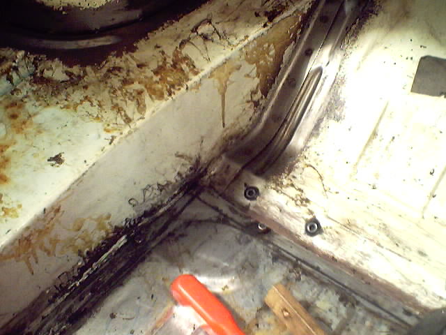 Interior floor pan and structural supports with rust and debris