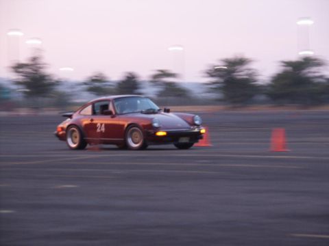 2001 Mercury Grand Marquis - A vintage Porsche 911 navigates a course marked by orange cones during an event.