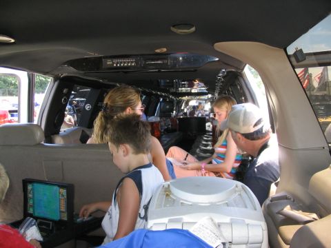 1986 Ford Bronco - Interior view of a modified SUV or van with passengers, including children, seated inside.