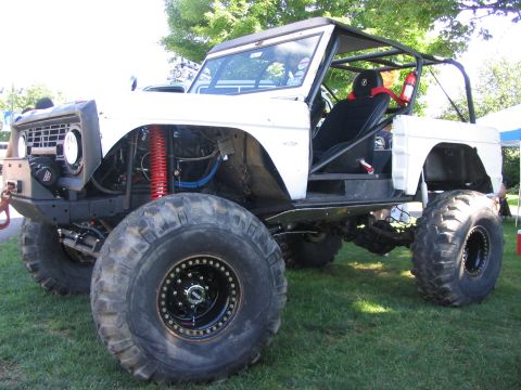 1986 Ford Bronco - Customized first-generation Ford Bronco modified for off-road use, oversized tires and a roll cage.