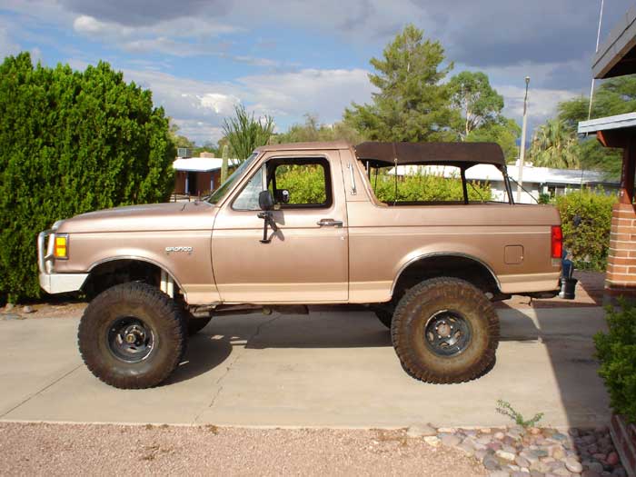 1989 Ford Bronco with a brown soft top, side view