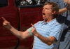 1976 Ford F-150 - A man in a light blue polo shirt gestures emphatically while looking off to the side.