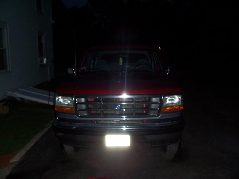 Front view of a red 1992-1996 Ford Bronco with a gray grille and headlights