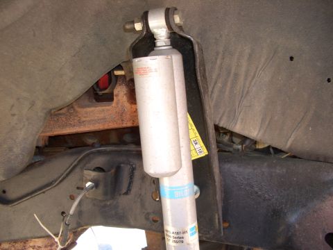 1990 Ford Bronco - Close-up view of a rear shock absorber assembly, Bilstein branding and a yellow sticker labeled SK 18.