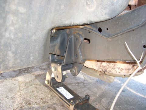 1990 Ford Bronco - Detail of vehicle frame and suspension components, showing rust and wear.