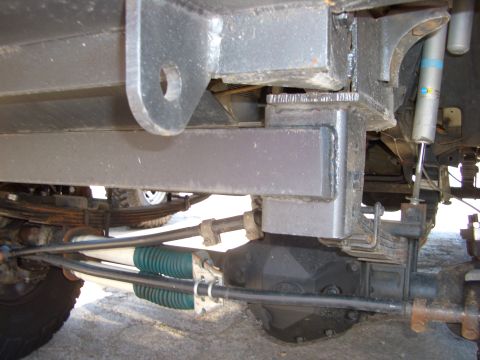 1990 Ford Bronco - Close-up of the vehicle's rear axle and suspension components, showing leaf springs and shock absorbers.