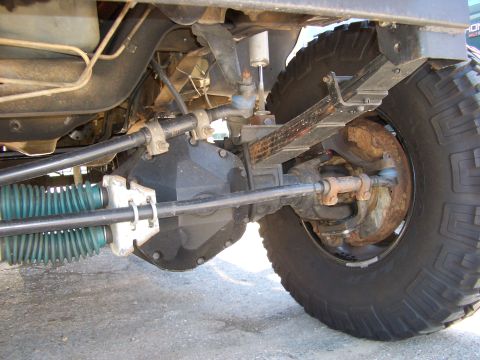 1990 Ford Bronco - Close-up view of the vehicle's undercarriage, focusing on the suspension and steering system.