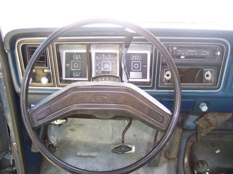 1978 Ford Bronco - The interior of a classic Ford truck shows its dashboard with gauges and radio.