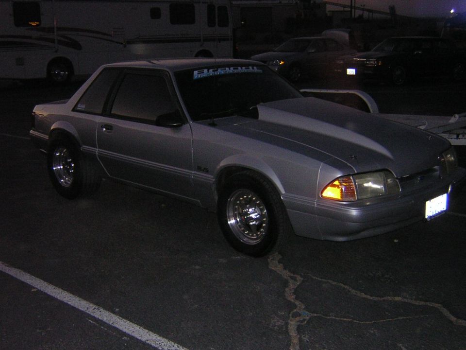 Silver Fox-body Ford Mustang LX coupe parked at dusk with drag-style wheels