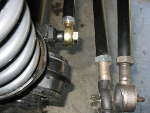 1995 Ford Bronco - Detail shot of suspension parts, including a large coil spring and adjustable linkages.