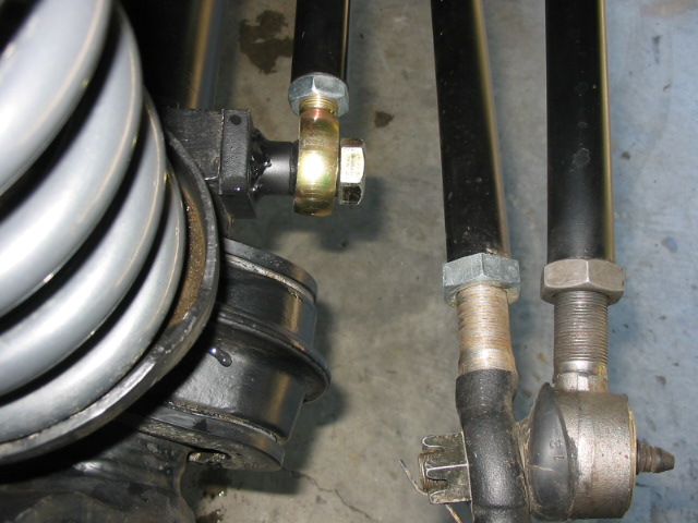 Close-up of tie rod ends, castellated nut and steering knuckle components