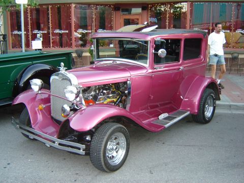 1990 Ford Thunderbird - Customized hot rod sedan parked outdoors with a man standing nearby.