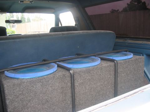 1986 Ford Bronco - A custom subwoofer box with three blue-trimmed speakers is installed in the rear of the vehicle.