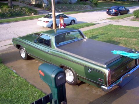 1970 Ford Ranchero - Green 1970 Ford Ranchero with a black bed cover is parked in a driveway.