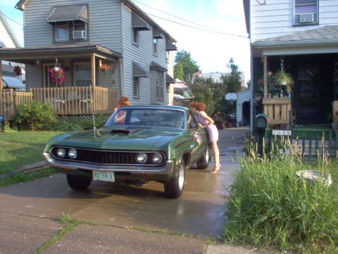 1970 Ford Ranchero - A green 1970 Ford Ranchero is parked in a driveway, with two women standing near the vehicle.