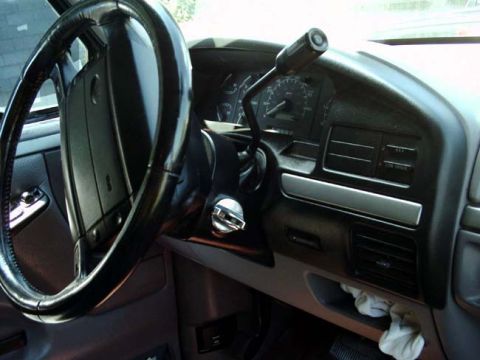 1994 Ford Bronco - Interior view of a 1994 Ford Bronco, showing the steering wheel, dashboard, and gear shifter.