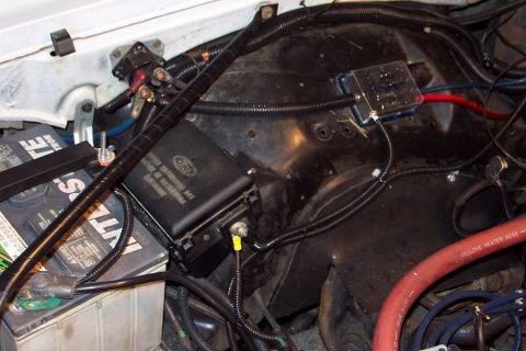 1985 Ford Crown Victoria LTD - Close-up of a Ford fuse box and battery, showing engine bay wiring and components.