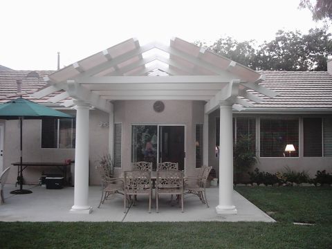 1978 Ford Bronco - Outdoor patio area with a table and chairs set up for dining, complete with an umbrella for shade.