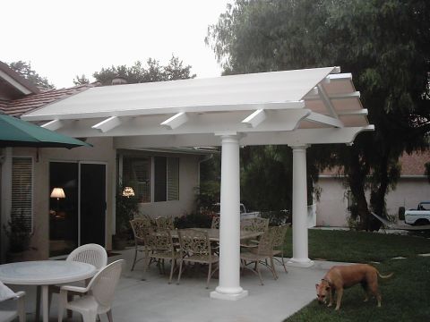 1978 Ford Bronco - Outdoor patio area with furniture and a dog, under a white pergola.