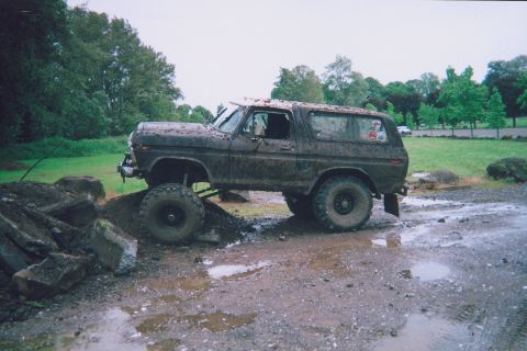 1978 Ford Bronco - This lifted 1978 Ford Bronco is covered in mud and appears to be navigating an obstacle course.