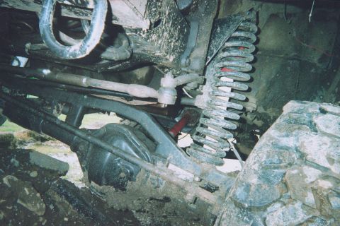 1978 Ford Bronco - This photo shows the muddy front suspension and differential of an off-road vehicle.