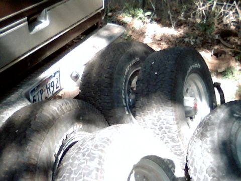 1992 Ford Bronco - Several spare tires are visible, along with a license plate on the rear of a vehicle.
