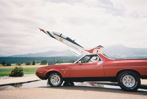 1972 Ford Ranchero - A red 1972 Ford Ranchero is parked in front of a U.S. Air Force jet, likely at a show or museum.