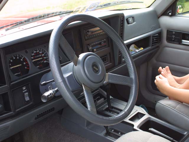 Jeep dashboard with leather-wrapped steering wheel, gauges and automatic shifter