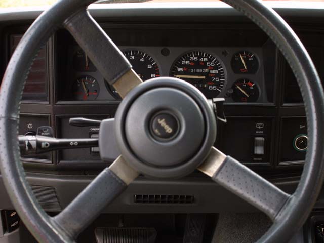Jeep gauge cluster framed by gray steering wheel, odometer near 131882