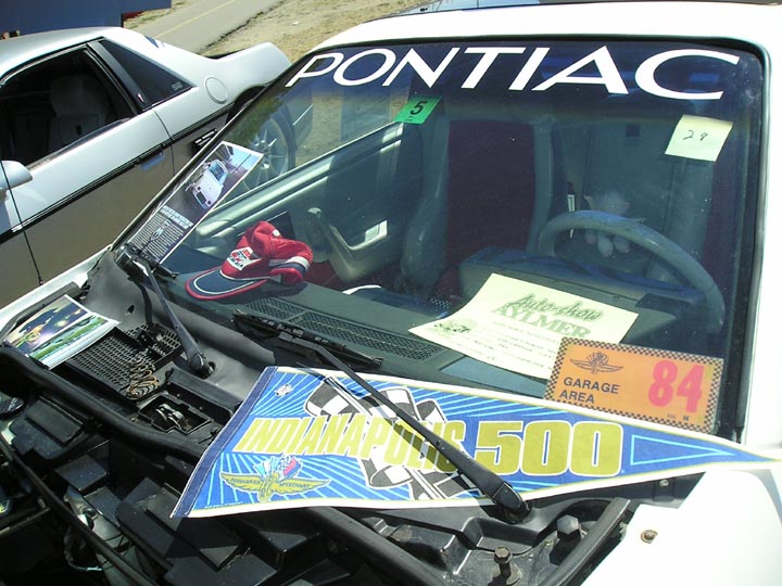 White 1984 Pontiac Fiero interior with Indianapolis 500 pennant and garage area sticker