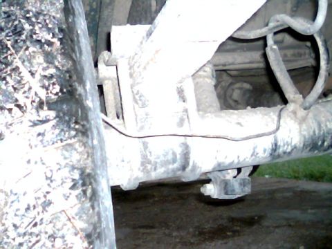 1992 Ford Bronco - Close-up view of the rear axle and suspension system of a vehicle.