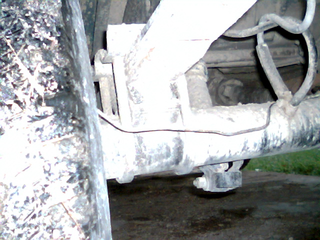 Close-up of rear axle, leaf springs, and brake lines on a vehicle