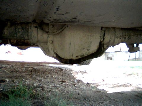 1992 Ford Bronco - The underside of a vehicle shows the rear differential and part of the axle assembly.