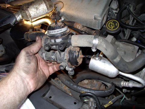 1990 Lincoln Town Car - Two 3/8" mounting bracket bolts, three air pump hose clamps and two vacuum hoses disconnected and this air pump diverter valve will actuall…