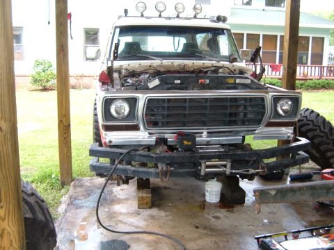 1978 Ford Bronco - 1978 Ford Bronco front end is visible with its hood open, revealing the engine compartment.